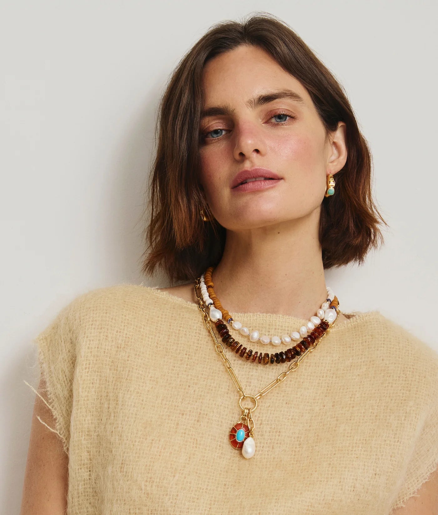 Stylish Piet Hoop Earrings in Bitter Orange showcasing the unique design of gold-plated brass with faceted orange hessonite garnet and amazonite cabochons.