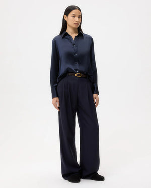 Back view of the Joey Shirt in Midnight featuring the inverted box pleat and raw shirttail hem designed by TWP.