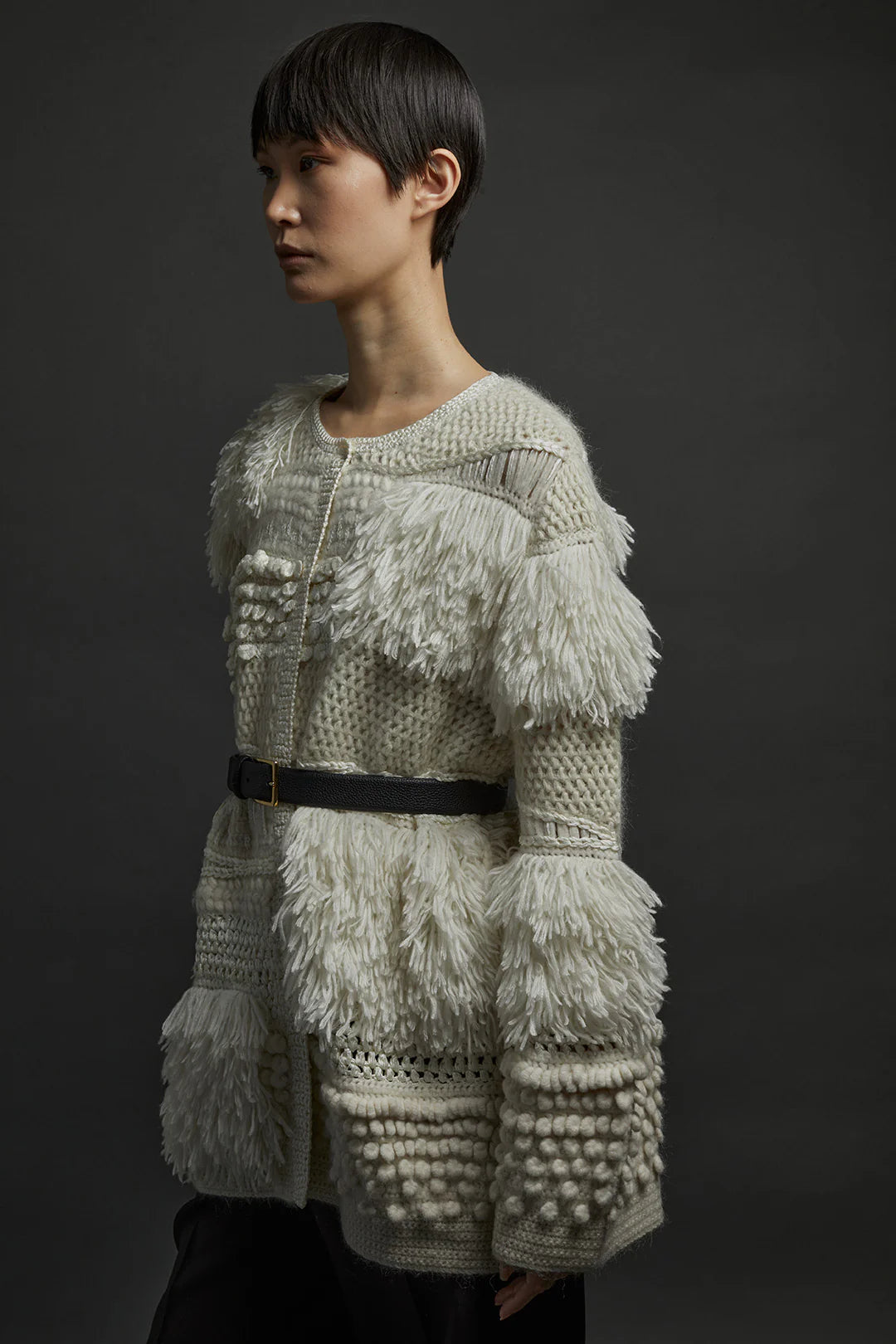 A flat lay of the Heirlome Vida Cardigan in Cream, emphasizing its soft texture and elegant color.