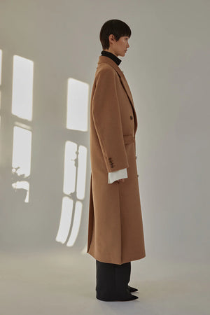 Side view of the Lilli Coat in Camel featuring its tailored midi length and side vents.
