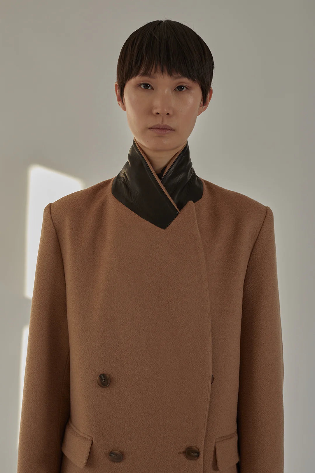 Styled outfit featuring the Lilli Coat in Camel paired with chic accessories.