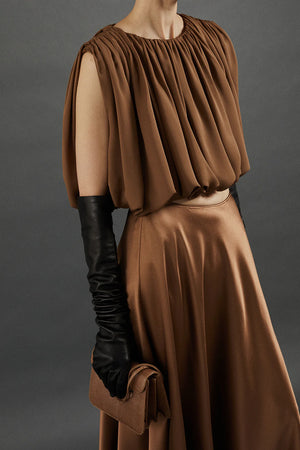 Heirlome Penelope Top in Sepia displayed on a hanger, showcasing the elegant fabric and design.