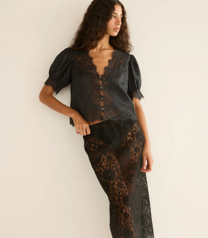Dôen Idella Top in Black presented with mother-of-pearl buttons down the front.