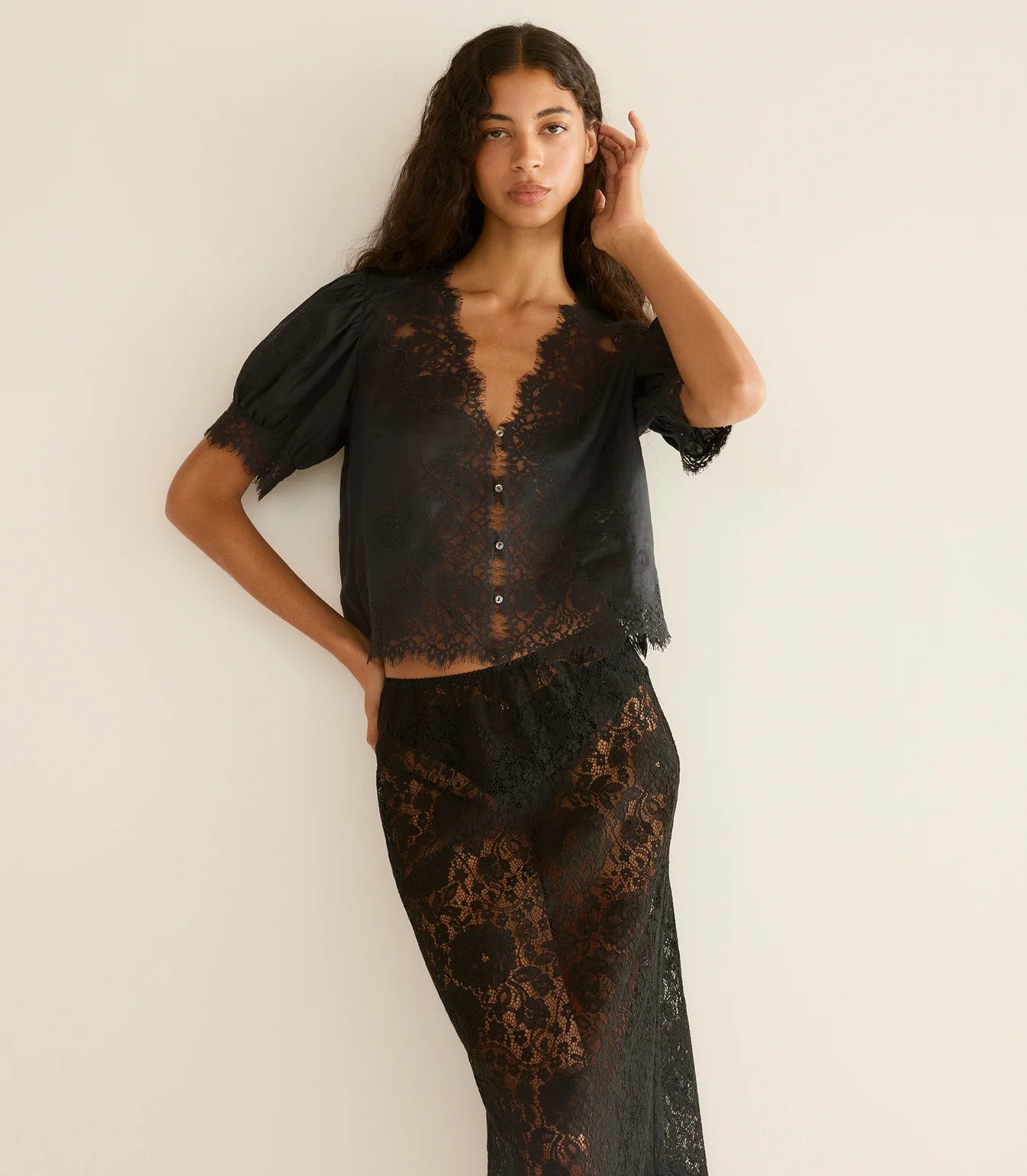 Model wearing the Dôen Idella Top in Black with a beautiful breeze capturing its lightweight fabric.