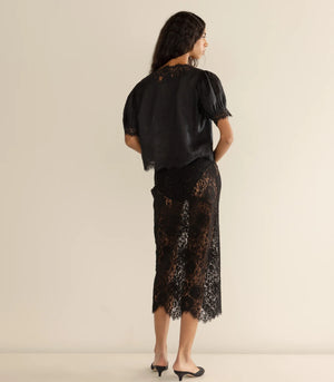 The Dôen Idella Top in Black showcasing lace insets on the sleeves and bodice.