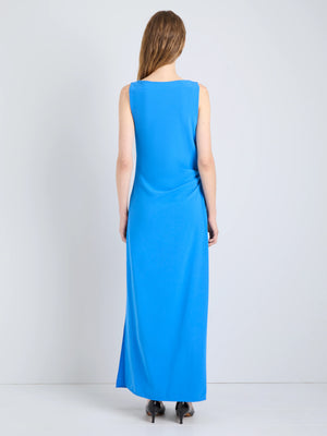 Indria Dress in New Blue, displayed from the side to emphasize the ruching and flow of the fabric.