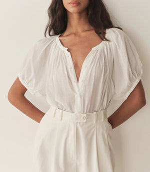 The back view of the Dôen June Top in Salt, emphasizing the full raglan sleeves and flowy design.