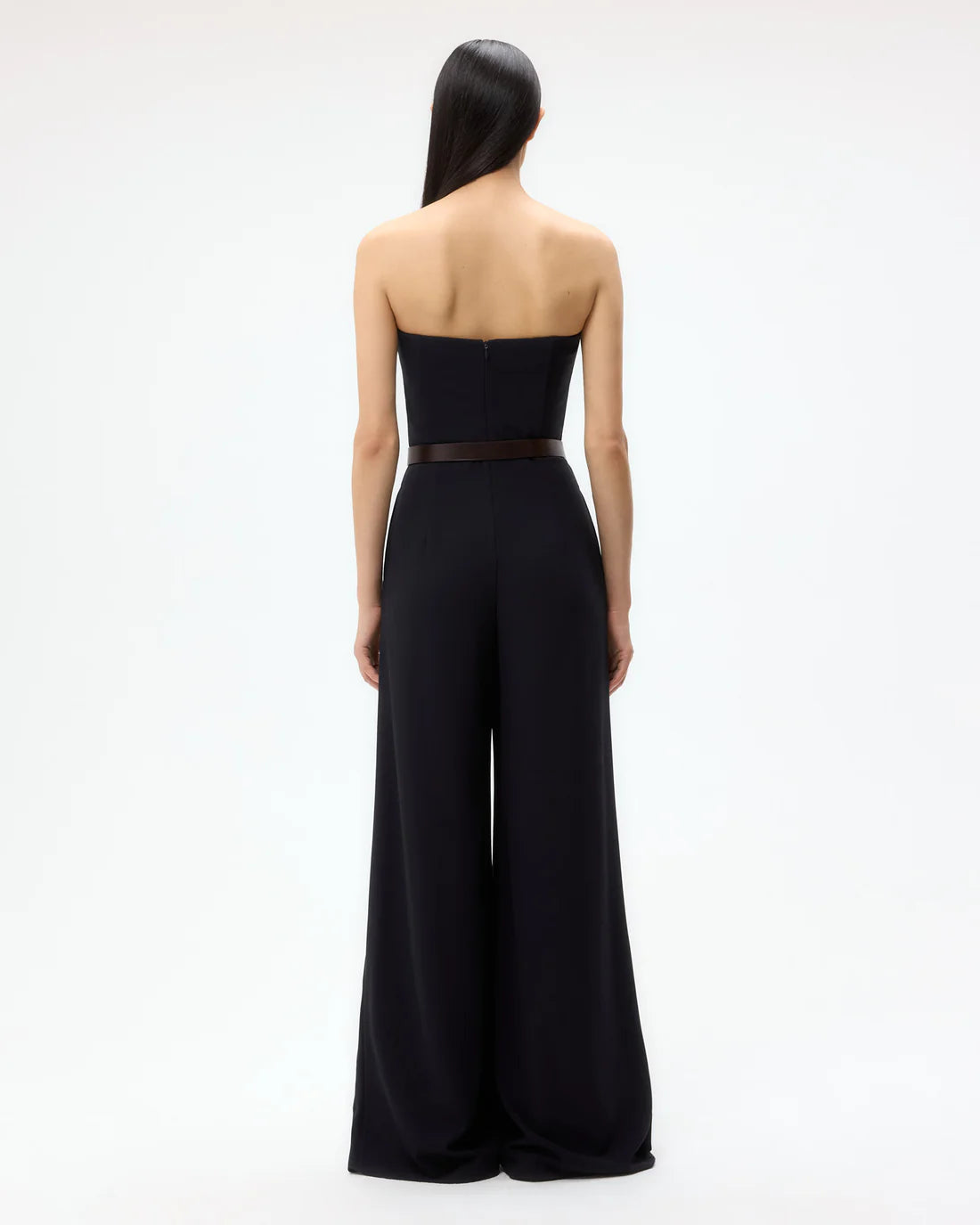 Model wearing the Jade Jumpsuit in Midnight, highlighting its chic and modern design, perfect for evening wear.