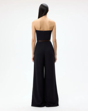 Model wearing the Jade Jumpsuit in Midnight, highlighting its chic and modern design, perfect for evening wear.