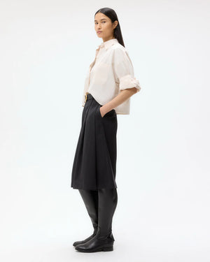 Side angle of the Next Ex Shirt in Pink Tint highlighting the boxy silhouette and double roll button cuffs.