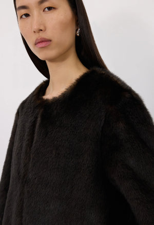 Fashionable display of the Moore Faux Fur Coat in Grizzly, emphasizing its minimalistic and elegant design.