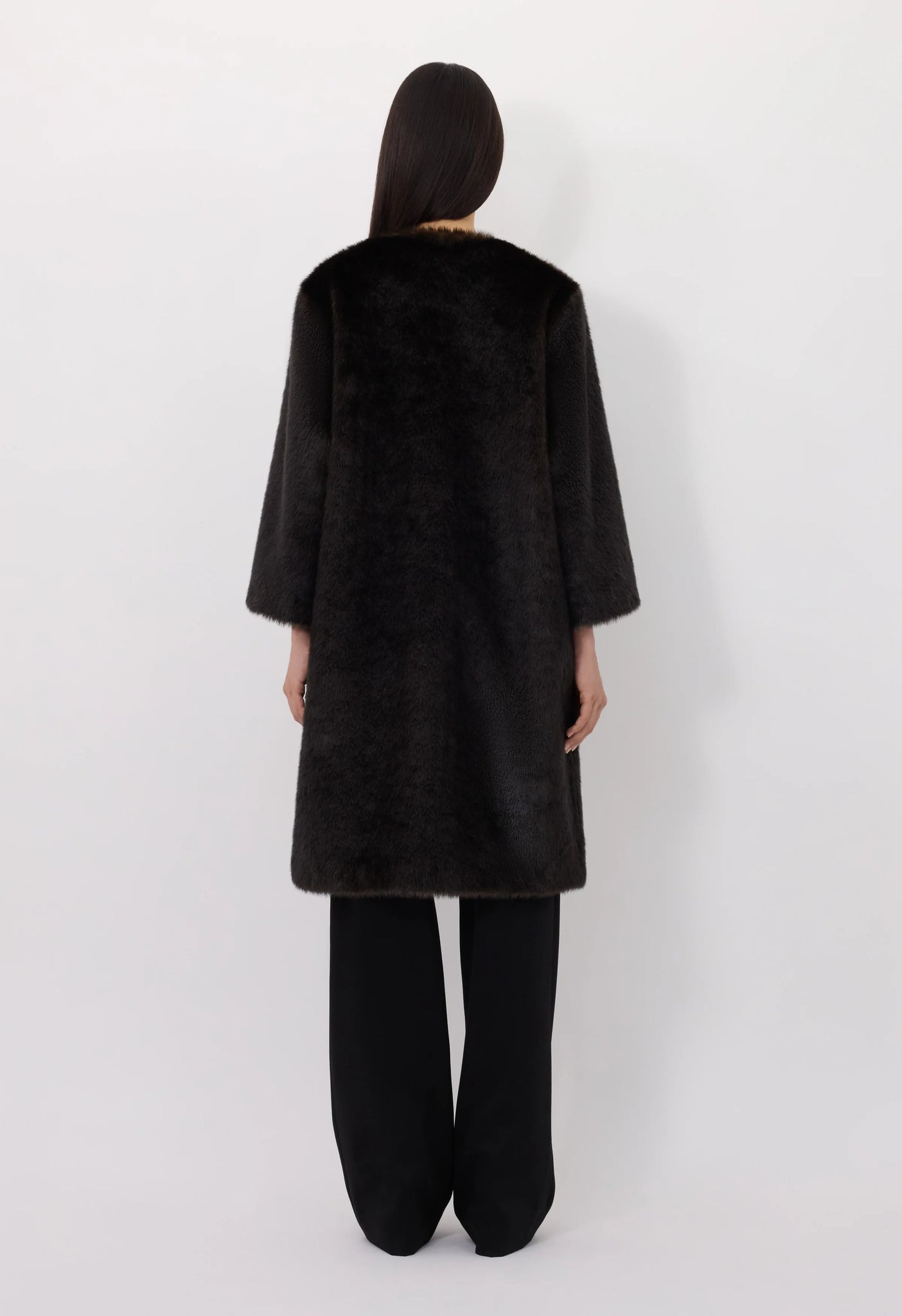 Model wearing the Moore Faux Fur Coat in Grizzly, perfect for a chic, casual look.
