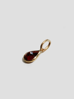 Lifestyle image of the Scarlet Teardrop Charm in Garnet on a charm holder, illustrating its elegant design and craftsmanship.