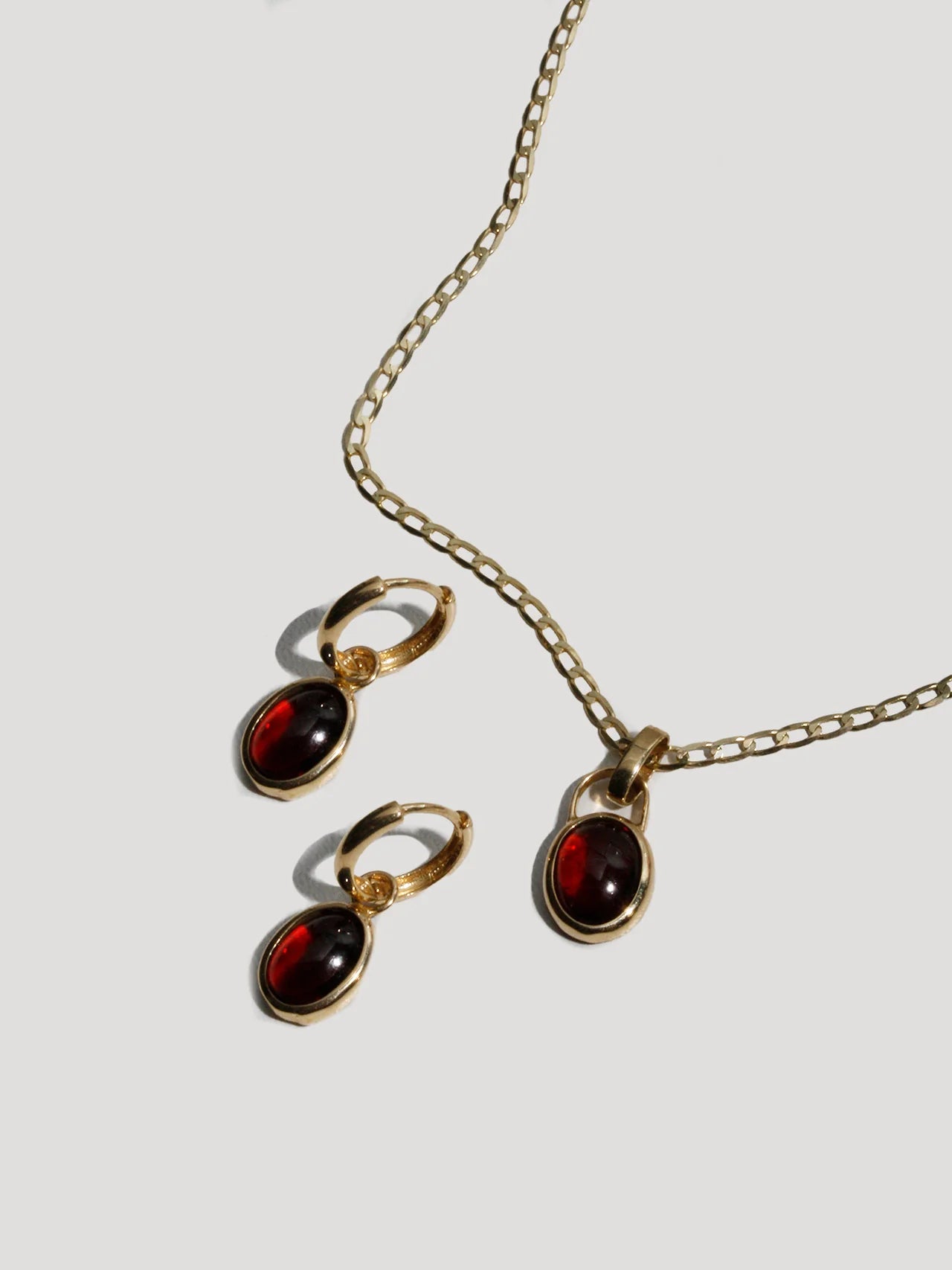 Close-up view of the Scarlet Amulet Pendant in Garnet highlighting its intricate design and protective amulet inspiration.