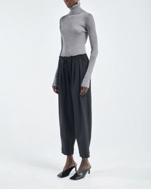 Close-up of Barrel Leg Drawstring Pant in Black, showcasing the fabric texture and drawstring details.