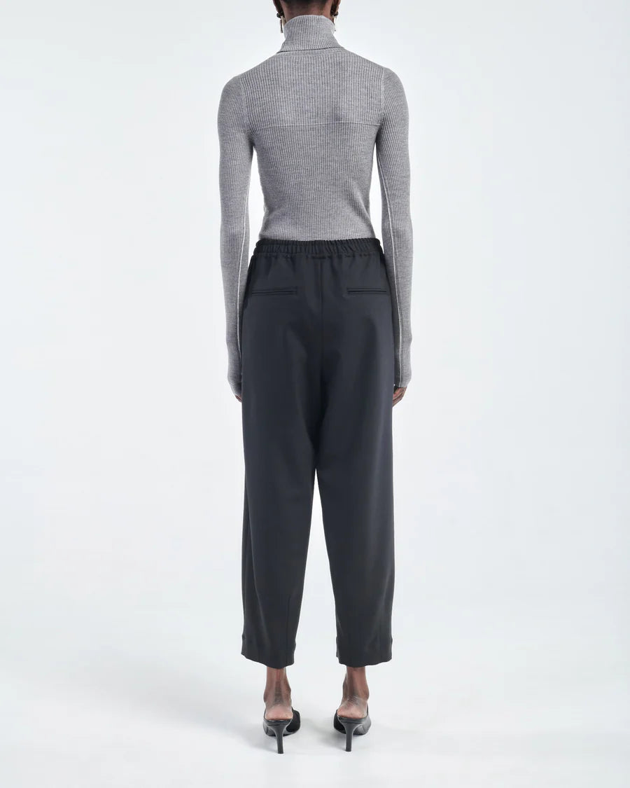 Barrel Leg Drawstring Pant in Black displayed on a model, highlighting the fit and design.