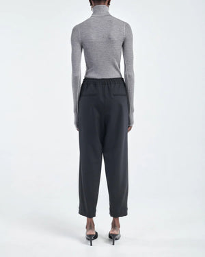 Barrel Leg Drawstring Pant in Black displayed on a model, highlighting the fit and design.