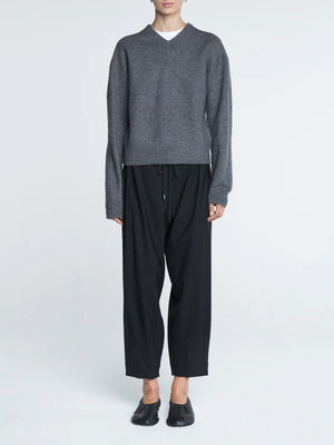 Barrel Leg Drawstring Pant in Black with focus on the ankle taper and pleat front detail.