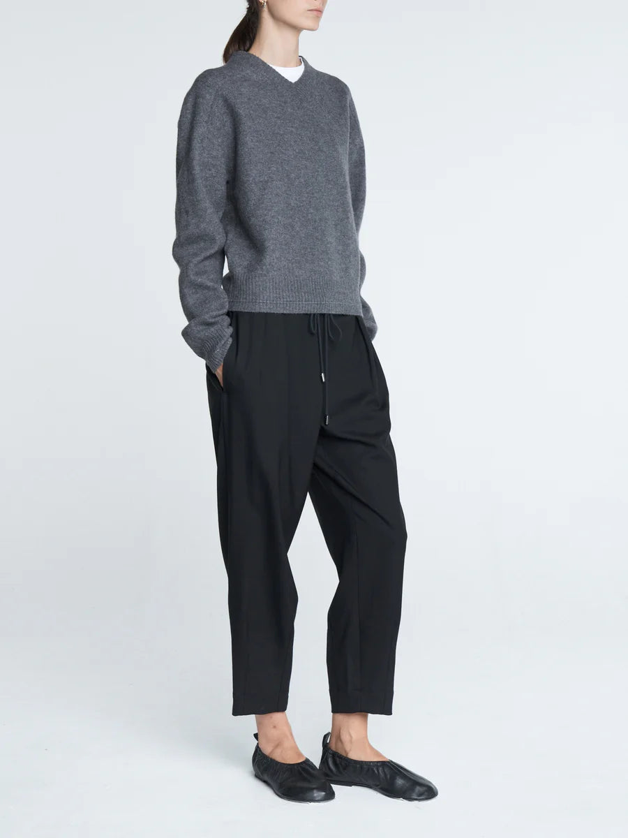 Model wearing Barrel Leg Drawstring Pant in Black for a casual look, paired with a simple top.