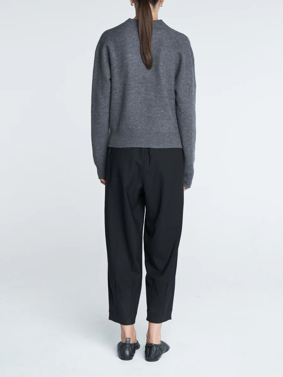 Barrel Leg Drawstring Pant in Black styled for a chic outfit, featuring side slit pockets.