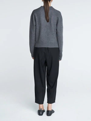 Barrel Leg Drawstring Pant in Black styled for a chic outfit, featuring side slit pockets.
