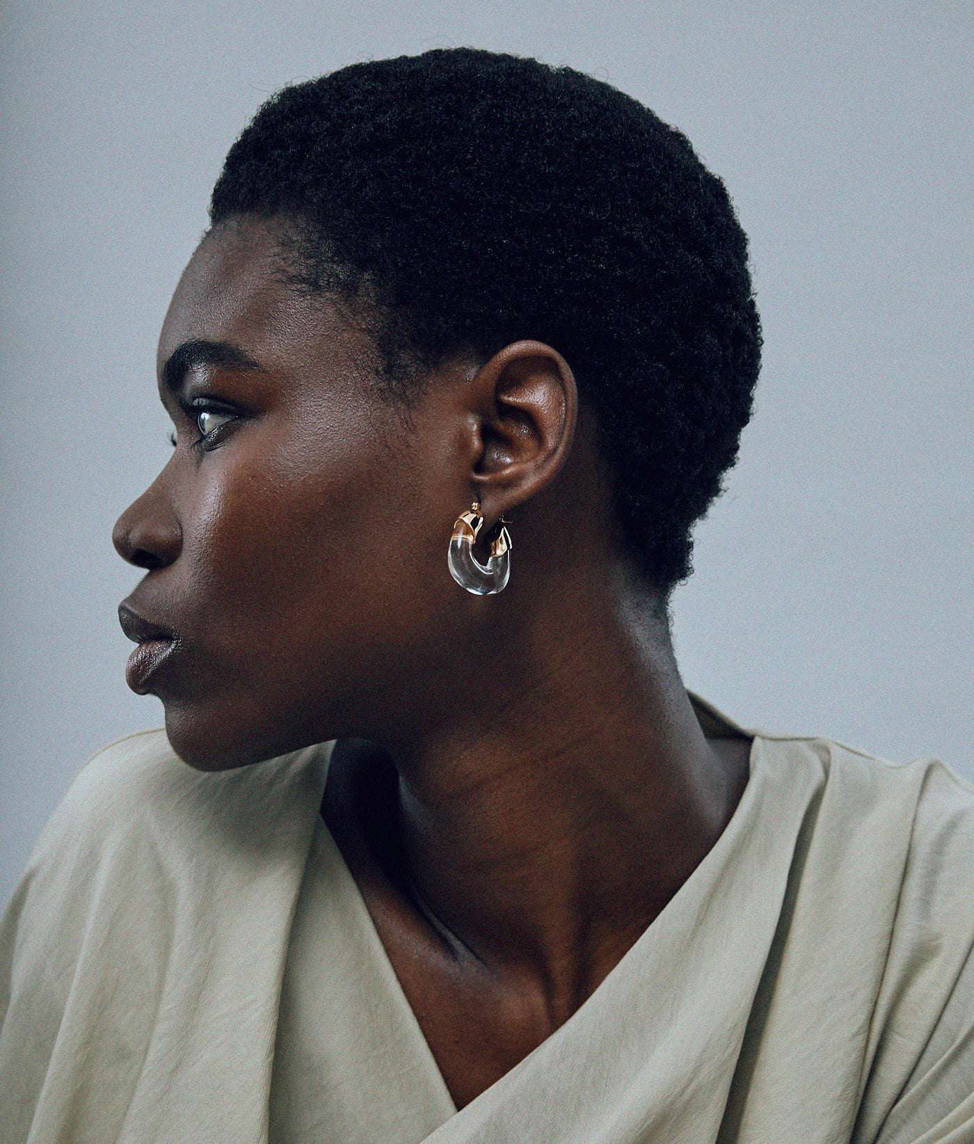 Close-up view of Mini Organic Hoops in Clear, showcasing the unique texture and design by Lizzie Fortunato.