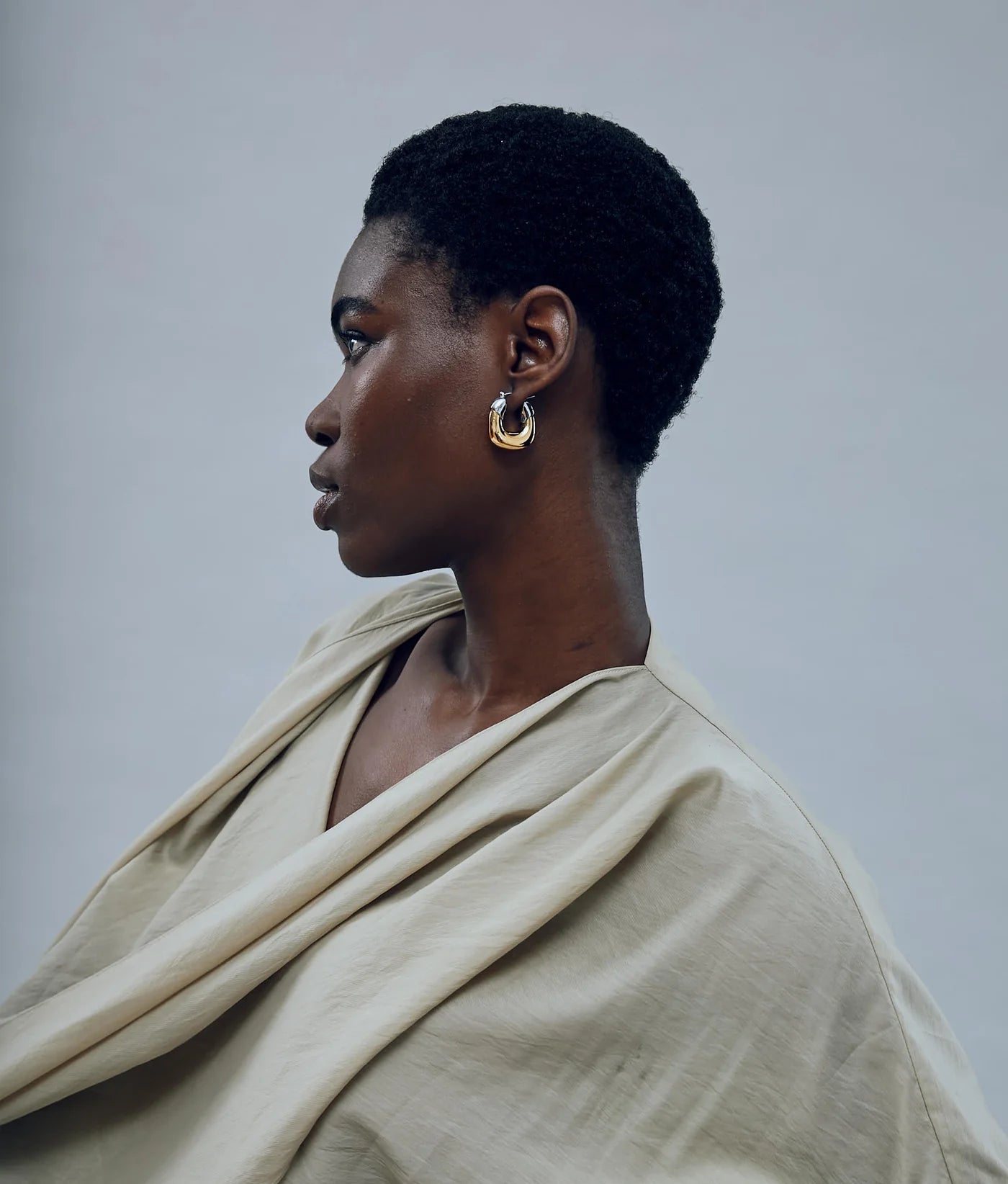 Elegant gold and silver-plated brass Mini Organic Hoops in Mixed Metal, perfect for versatile styling.