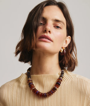 Close-up of Lizzie Fortunato Organic Hoops in Espresso, showcasing gold-plated brass and resin details for a chic look.