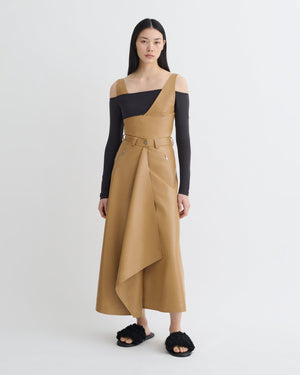 Close-up view of the Neith Skirt in Oak highlighting the texture and draping of the alt-leather material from Nanushka.