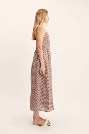 Casual styling of the Callie Dress in Petite Mocha Gingham with a flowy maxi skirt and adjustable tie.