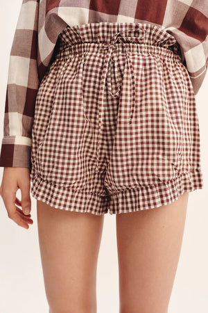 Model wearing Callie Shorts in Petite Mocha Gingham, paired with matching Callie Blouse for a trendy summer look.