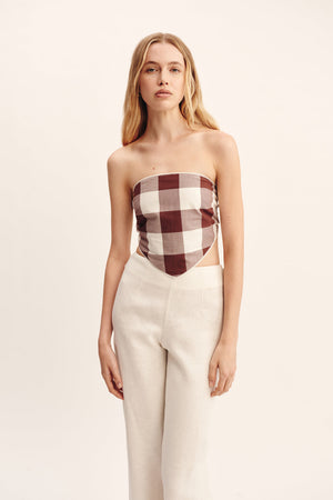 Model wearing the Callie Tie Top in Mocha Gingham, demonstrating its fit and effortless style perfect for any casual occasion.