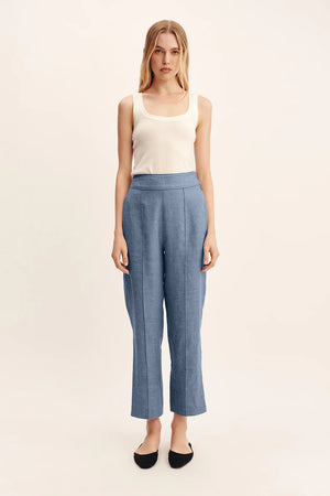 Detail shot of Thea Trousers in Steel Blue fabric, highlighting the premium 100% linen composition.