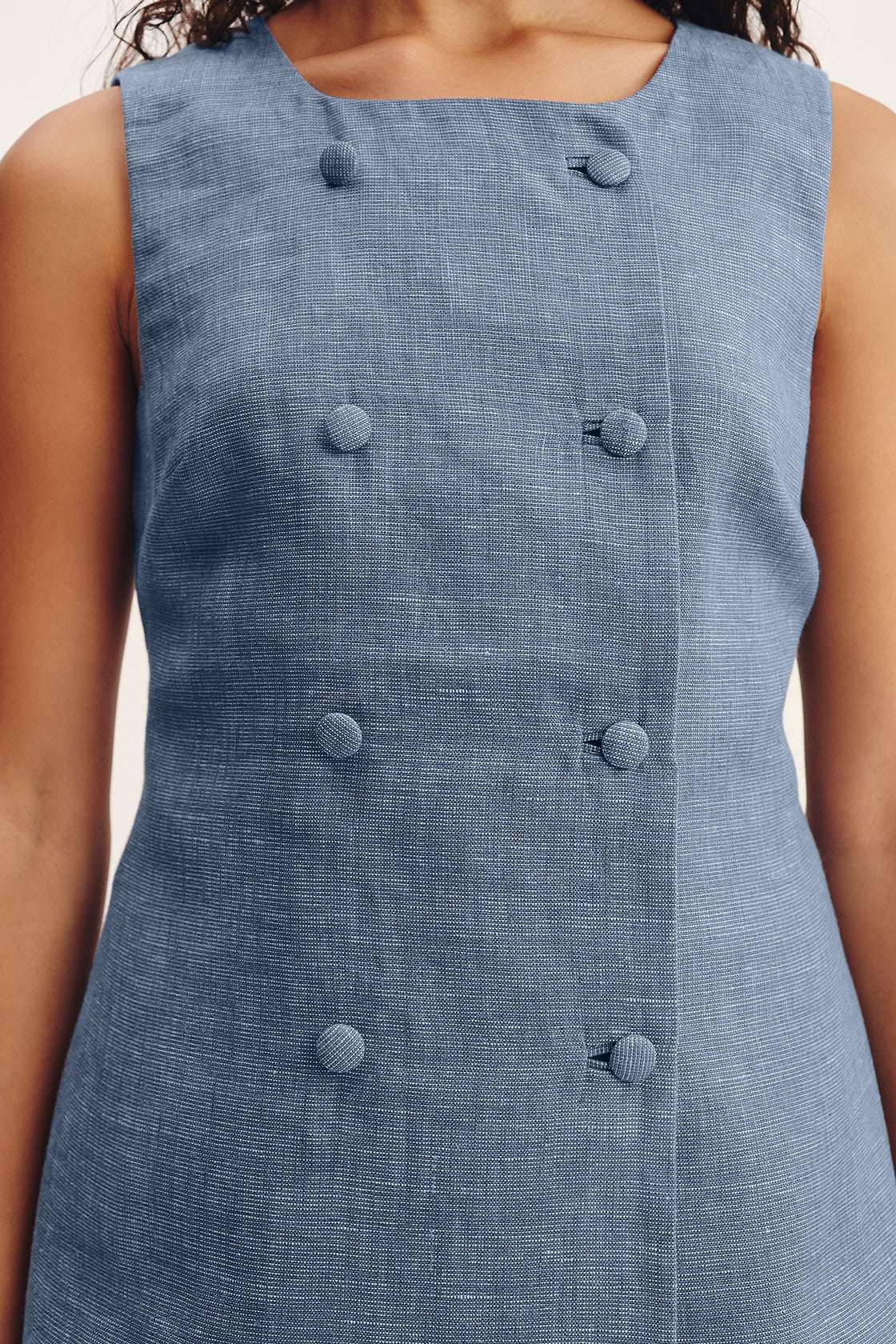 Thea Vest in Steel Blue flat lay showcasing its unique silhouette and craftsmanship details from Posse.