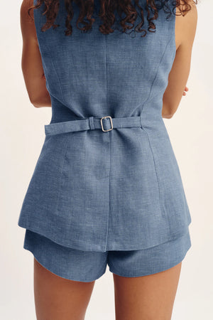 Model wearing Thea Vest in Steel Blue, styled with complementary fashion accessories for a trendy look.