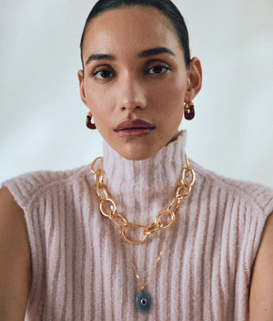 Mini Organic Hoops in Currant - Close-up view of gold-plated brass hoop earrings with a chic deep red resin finish.