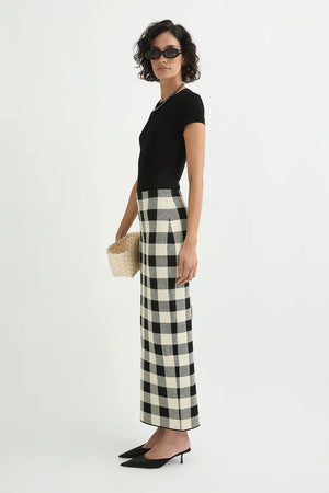 Model wearing the Pippa Skirt in Heritage Plaid styled with a simple black top, showcasing the versatile and chic look.