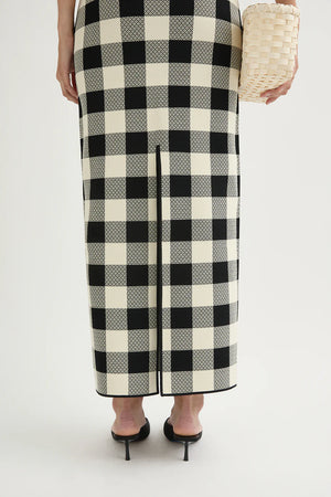 Styled flat lay of the Pippa Skirt in Heritage Plaid alongside coordinating pieces for a trendy outfit inspiration.