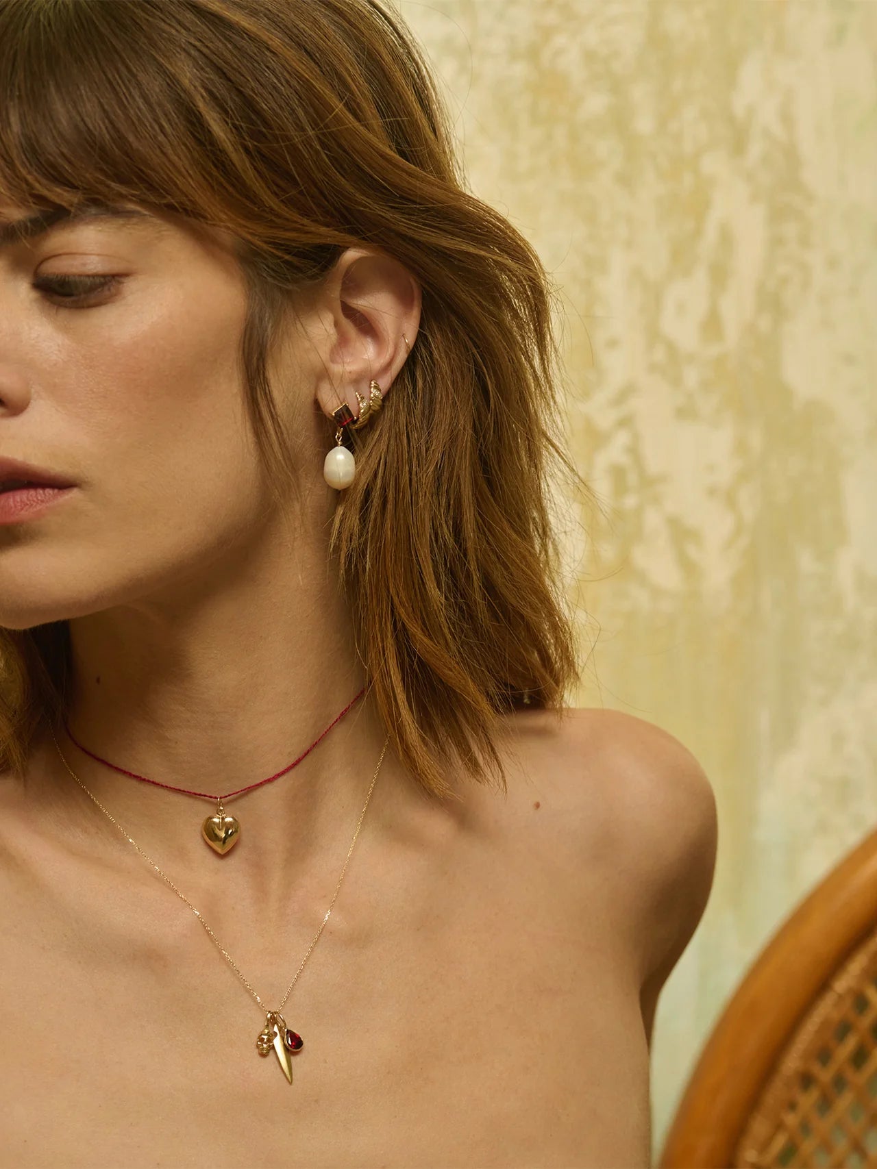 Side view of Gem Baroque Earrings in Garnet and Pearl highlighting the 14kt gold composition by Loren Stewart.