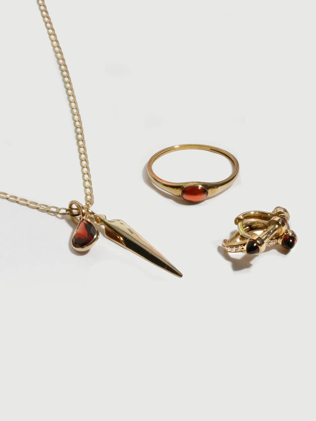 Close-up of the Dagger Pendant in Gold featuring fine detailing, crafted in solid 14k yellow gold by Loren Stewart.