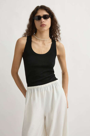 The elegant scooped neckline of the Finley Tank in Black displayed against a neutral background.