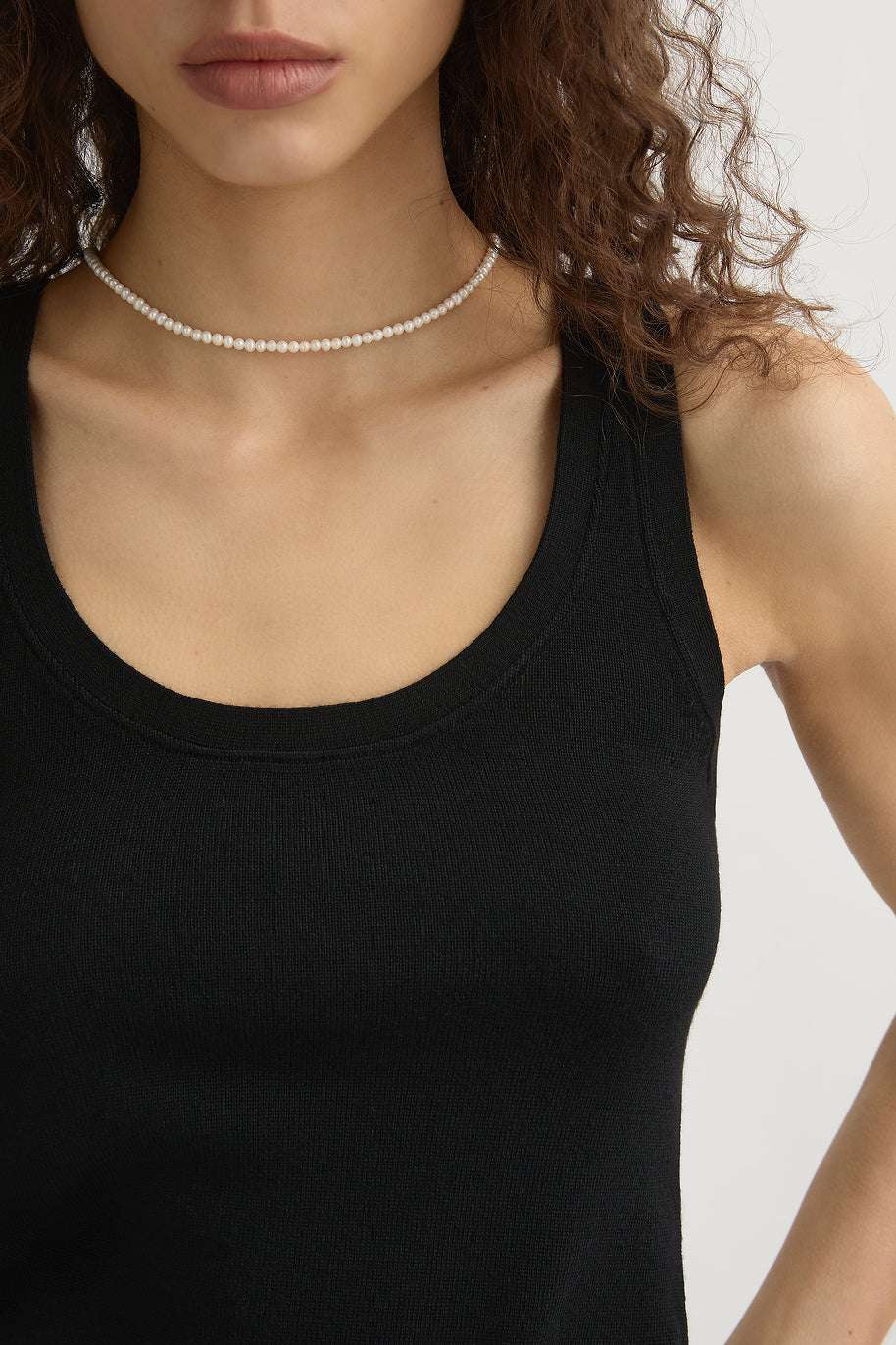 Flat lay of the Finley Tank in Black highlighting the lightweight 100% wool fabric.