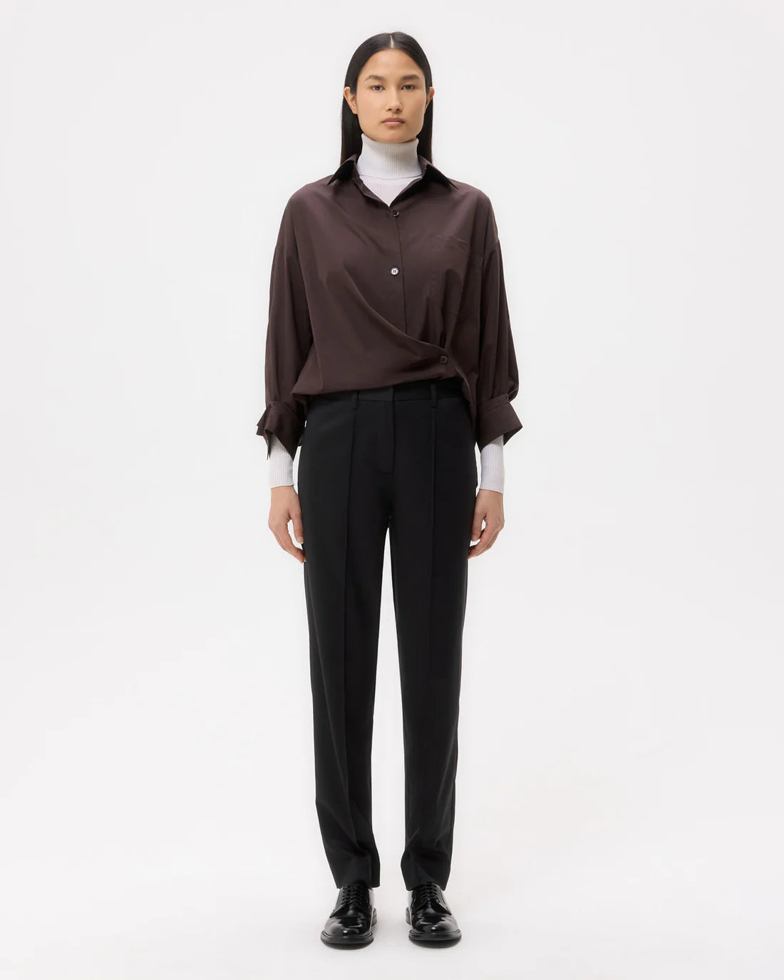 Close-up view of the Harrison Pant in Black, highlighting the tailored fit and smooth fabric texture.
