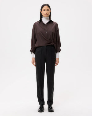 Close-up view of the Harrison Pant in Black, highlighting the tailored fit and smooth fabric texture.