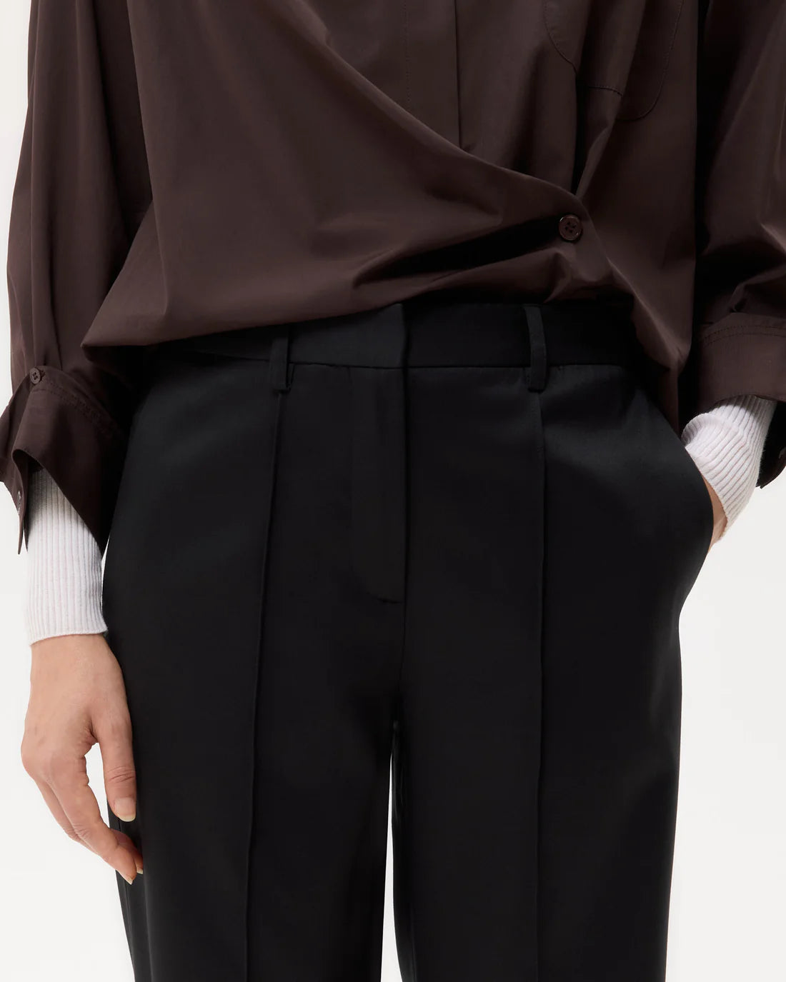 Harrison Pant in Black displayed against a neutral background, showcasing its sleek design and versatility.