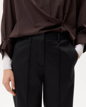Harrison Pant in Black displayed against a neutral background, showcasing its sleek design and versatility.