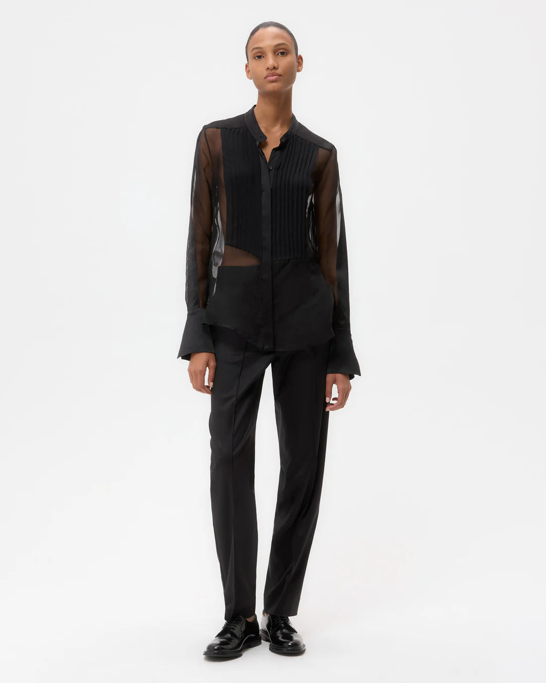 Back view of the Peyton Top in Black, showing the long, relaxed fit and construction details.