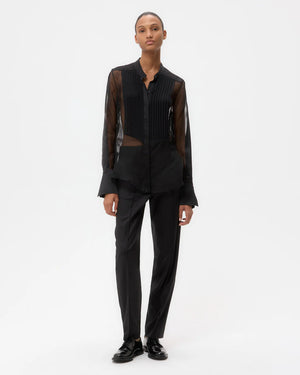 Back view of the Peyton Top in Black, showing the long, relaxed fit and construction details.