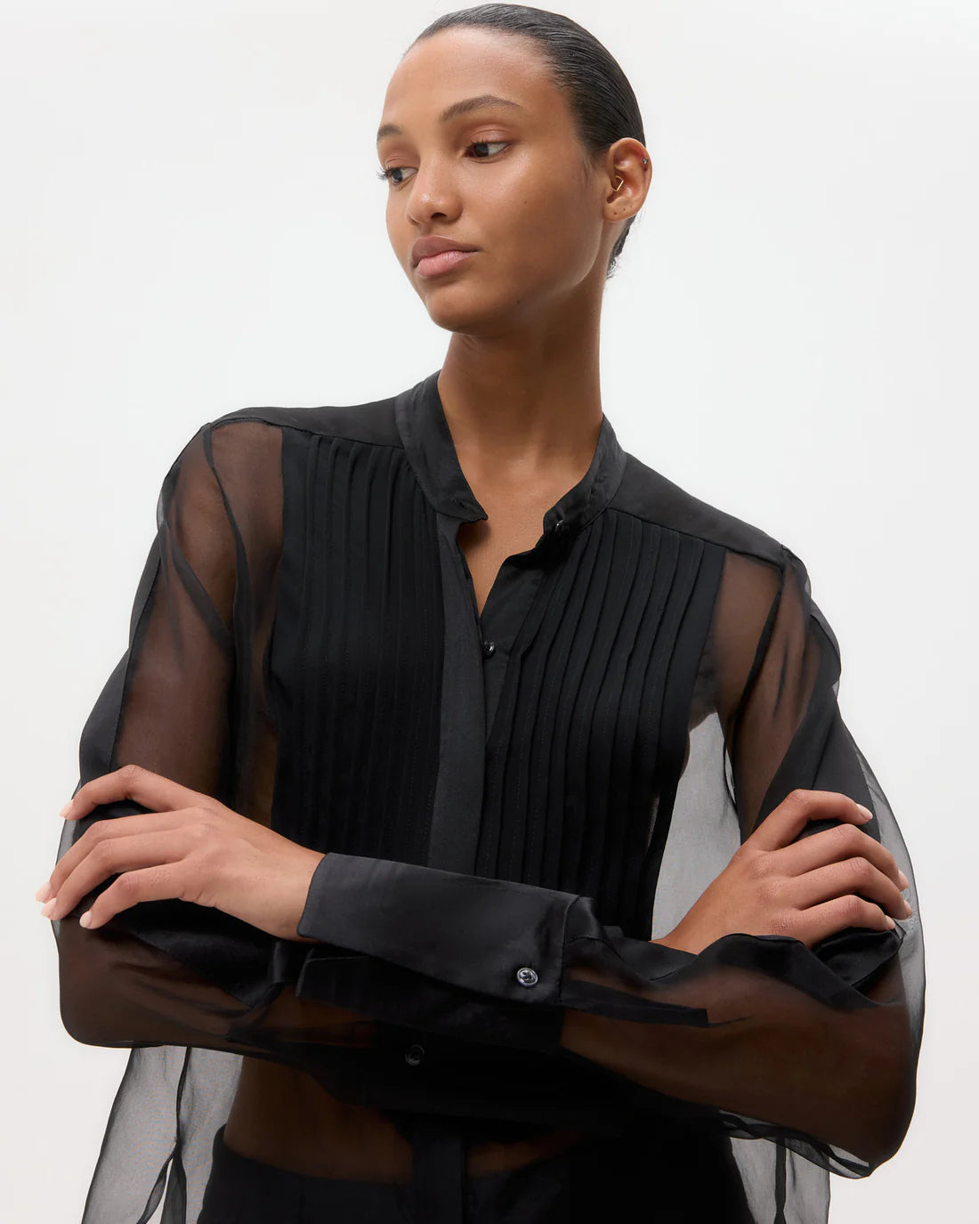 Peyton Top in Black laid flat, emphasizing the luxurious 100% silk fabric and sophisticated design elements.