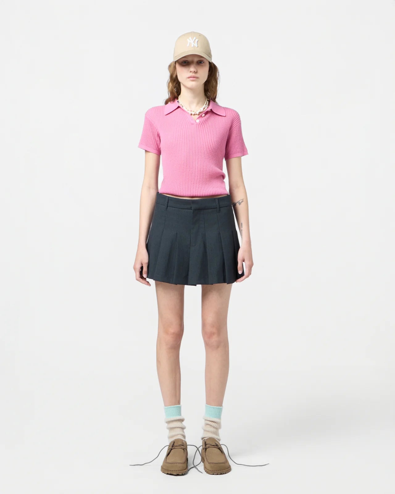 Close-up of Shrunken Polo in Rose detailing the three-button placket and signature branding at the neck.